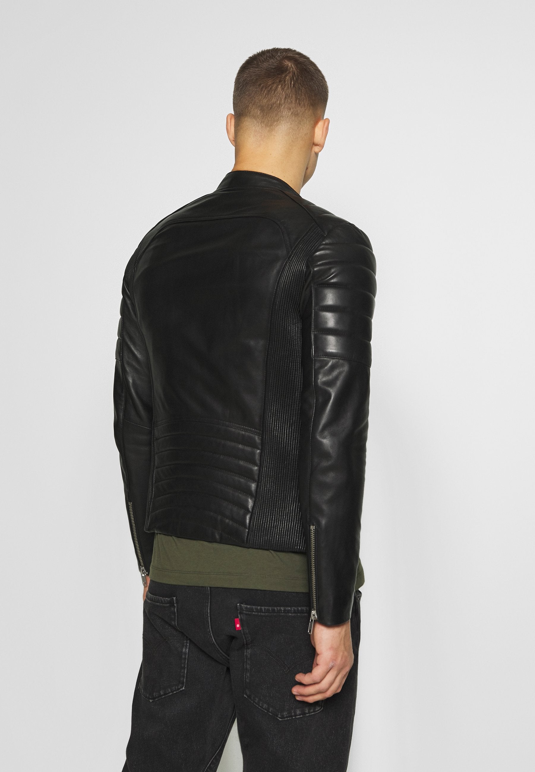 Men's black leather biker jacket with quilted shoulders and zip pockets